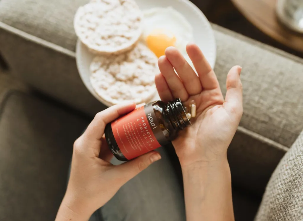 Pouring out supplements into hand - Top 7 Tips to Stay Active